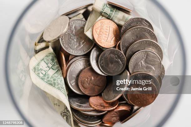 overhead view of american cents and banknotes in jar - montclair stock-fotos und bilder