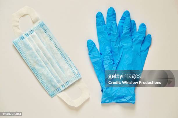 studio shot of surgical mask and latex gloves - surgical glove stock pictures, royalty-free photos & images