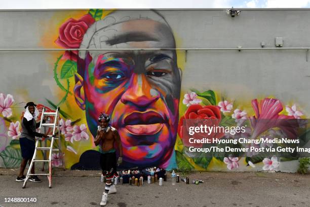 Artists "Detour" Thomas Evans, left, and "Hiero" are creating mural of George Floyd near the corner of High St. And E. Colfax Ave. In Denver,...