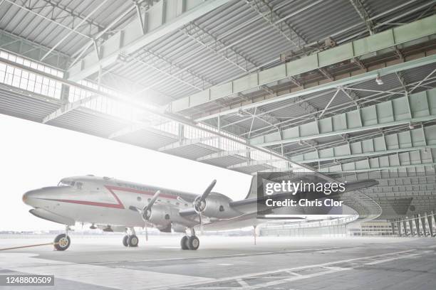 germany, berlin, small airplane in hangar at tempelhof airport - tempelhof vliegveld stockfoto's en -beelden
