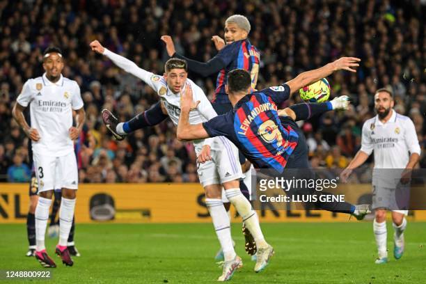 Barcelona's Polish forward Robert Lewandowski kicks the ball during the Spanish league football match between FC Barcelona and Real Madrid CF at the...