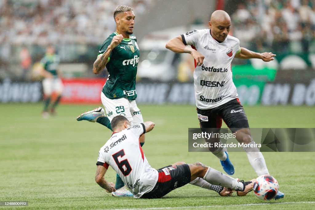 Rafael Navarro of Palmeiras competes for the ball with Claudinho