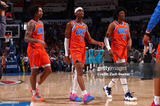 Jaylin Williams, Shai Gilgeous-Alexander, and Jaylen Williams of the Oklahoma City Thunder looks on during the game against the Phoenix Suns on March...