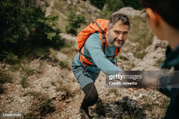 assistance during the hiking on mountain - explorer stock pictures, royalty-free photos & images