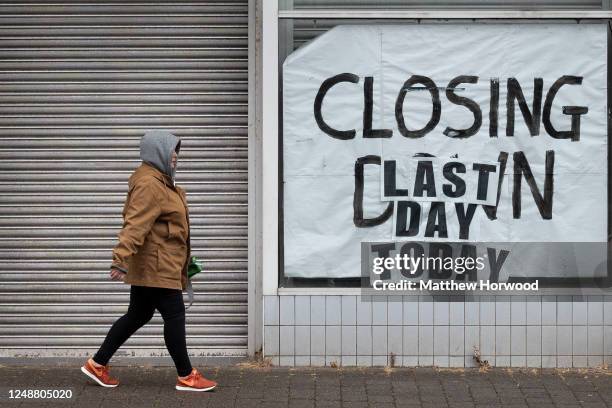 Woman walks passed a closed-down shop on June 10, 2020 in Aberdare, United Kingdom. The Welsh government has further relaxed COVID-19 lockdown...