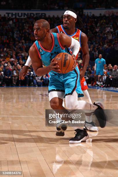 Chris Paul of the Phoenix Suns dribbles the ball during the game against the Oklahoma City Thunder on March 19, 2023 at Paycom Arena in Oklahoma...