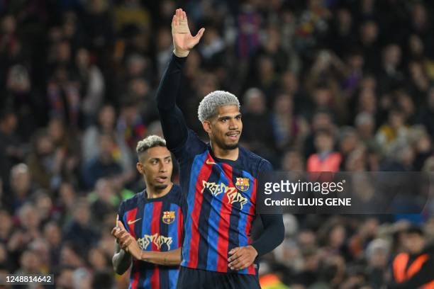 Barcelona's Uruguayan defender Ronald Araujo and Barcelona's Brazilian forward Raphinha celebrate at the end of the Spanish league football match...