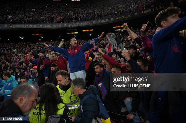 Barcelona's supporters celebrate at the end of the Spanish league football match between FC Barcelona and Real Madrid CF at the Camp Nou stadium in...