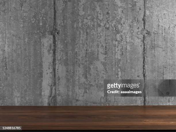wooden desk against clean concrete wall - table stock pictures, royalty-free photos & images