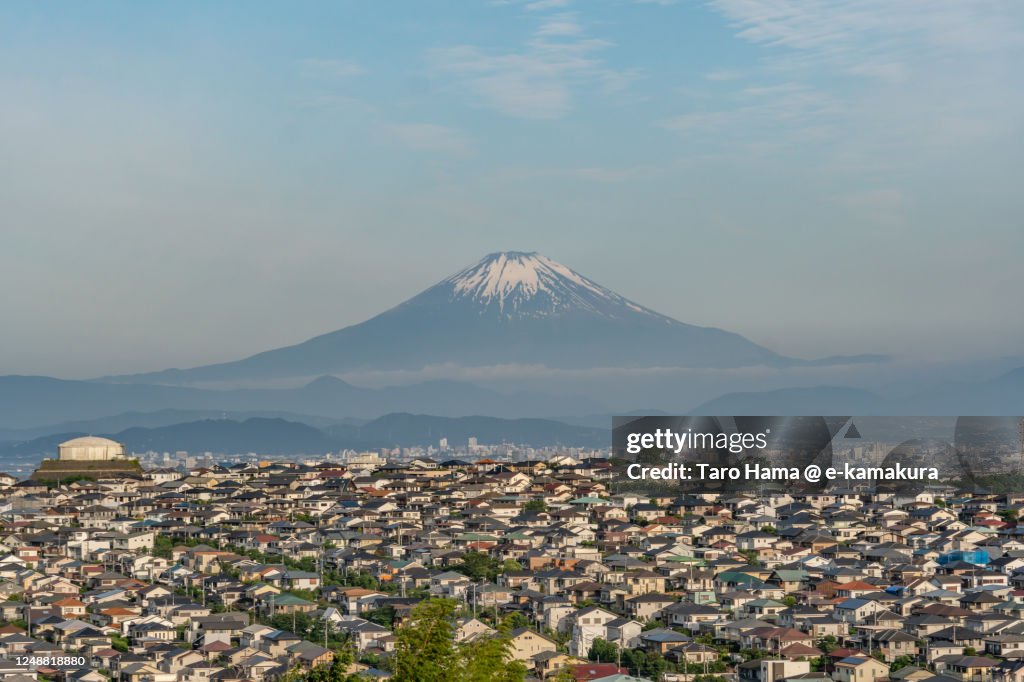 Snowcapped Mt. Fuji and the residential districts on the hill in Kanagawa prefecture of Japan