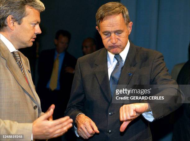 French minister for Economic affairs, Finance and Industry, Francis Mer gestures in front of his Belgian counterpart Didier Reynders prior to the...