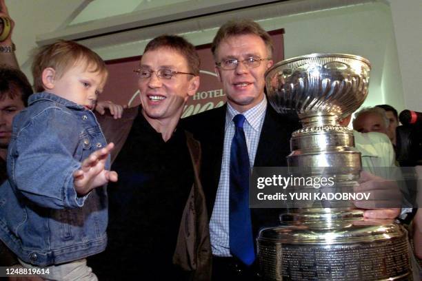 Russian NHL ice hockey player Igor Larionov of the Detroit Red Wings, his four-year old-son Igor , and Russian Sport Minister and former NHL player...