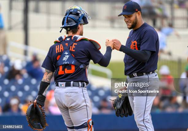 Detroit Tigers catcher Eric Haase bumps fists with Detroit Tigers pitcher Eduardo Rodriguez on the mound during an MLB spring training game between...