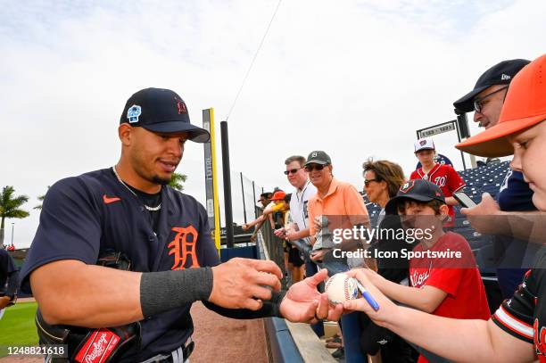 Detroit Tigers infielder César Hernández signs autographs for fans before an MLB spring training game between the Detroit Tigers and the Washington...