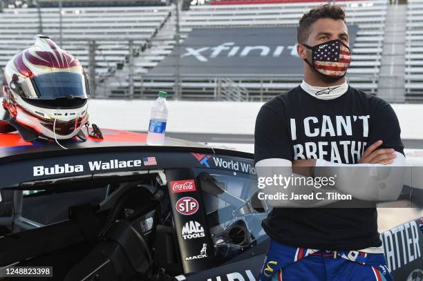 Bubba Wallace, driver of the Richard Petty Motorsports Chevrolet, wears a "I Can't Breathe - Black Lives Matter" t-shirt under his firesuit in...