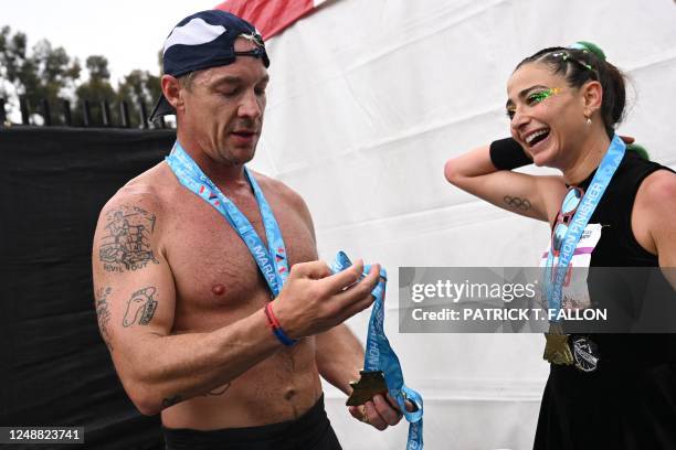 Diplo and Greek-US runner/actress Alexi Pappas after crossing the finish line during the 38th Los Angeles Marathon in Los Angeles, California, on...