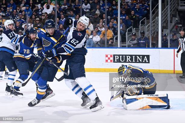 Marco Scandella and Joel Hofer of the St. Louis Blues defend the net against Nino Niederreiter of the Winnipeg Jets at the Enterprise Center on March...