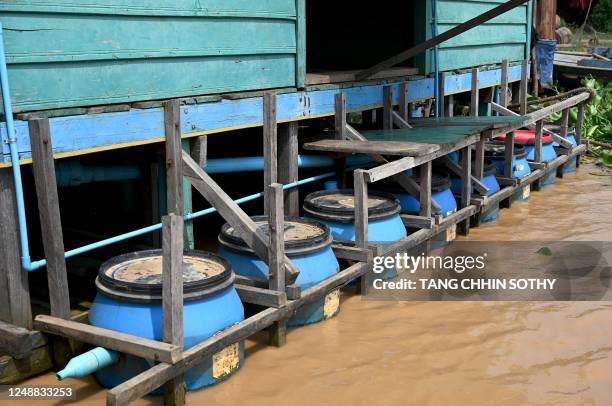 This photo taken on March 13, 2023 shows a floating toilets in Chong Prolay village on Tonle Sap lake in Siem Reap province. - Around 100,000 people...