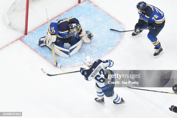 Joel Hofer of the St. Louis Blues makes a glove save on Nino Niederreiter of the Winnipeg Jets at the Enterprise Center on March 19, 2023 in St....