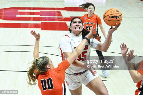 Alissa Pili of the Utah Utes is found going to the basket by Ellie Mitchell of the Princeton Tigers in the fourth quarter during the second round of...