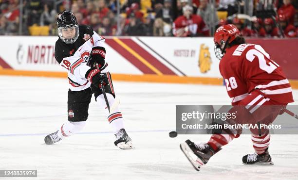 Sophie Jaques of the Ohio State Buckeyes attempts a shot as Maddi Wheeler of the Wisconsin Badgers defends in the second period during the Division I...