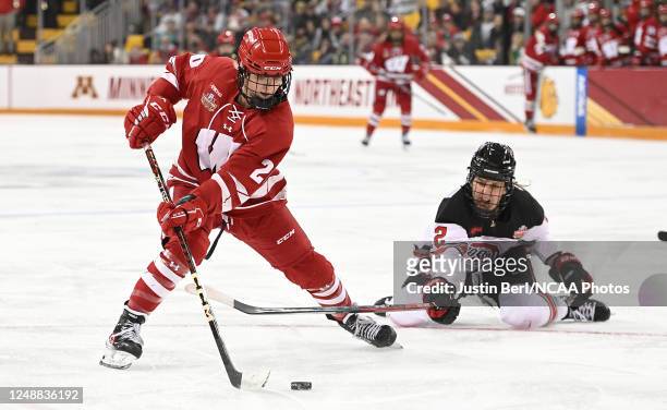 Vivian Jungels of the Wisconsin Badgers skates with the puck as Jennifer Gardiner of the Ohio State Buckeyes attempts a poke check in the third...