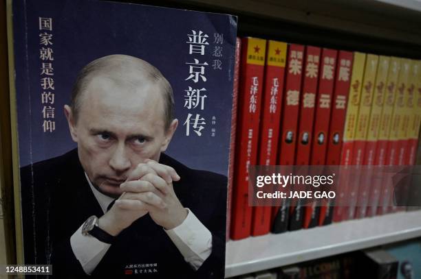 Book about Russian President Vladimir Putin is seen on a bookshelf, at a book store in Beijing on March 20, 2023. - Chinese President Xi Jinping...