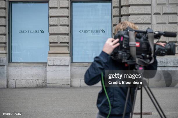 Television camera operator films in front of the Credit Suisse Group AG headquarters in Zurich, Switzerland, on Monday, March 20, 2023. UBS Group AG...