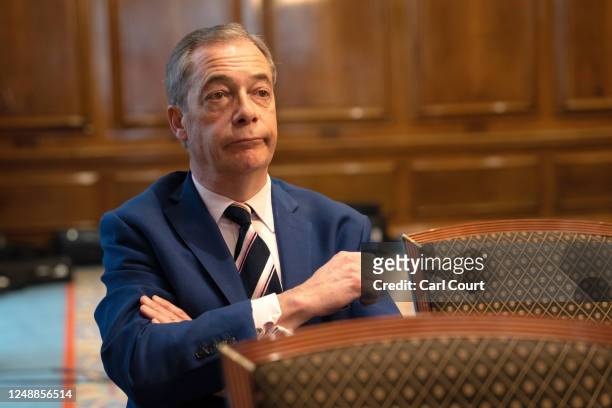 Reform UK honorary president Nigel Farage listens during a party press conference on March 20, 2023 in London, England. Reform UK was founded in 2018...