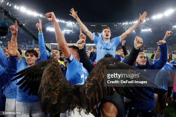 Lazio players celebrate after winning the Serie A match between SS Lazio and AS Roma at Stadio Olimpico on March 19, 2023 in Rome, Italy.