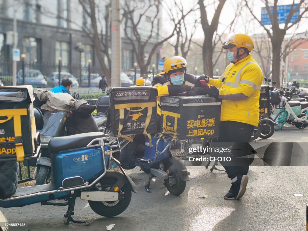 Chinese Delivery Riders BEIJING, CHINA - MARCH 20, 2023 - Food delivery workers wait for ...