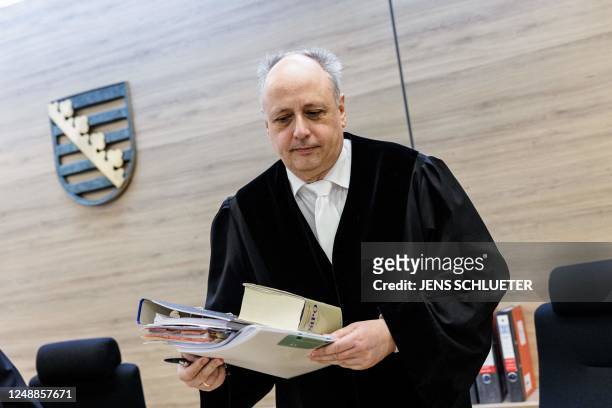 Presiding judge Andreas Ziegel arrives to take his seat at the Higher Regional Court in Dresden, eastern Germany on March 20, 2023 prior to a hearing...