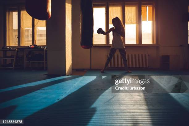 boxing in dark gym - muay thai stock pictures, royalty-free photos & images