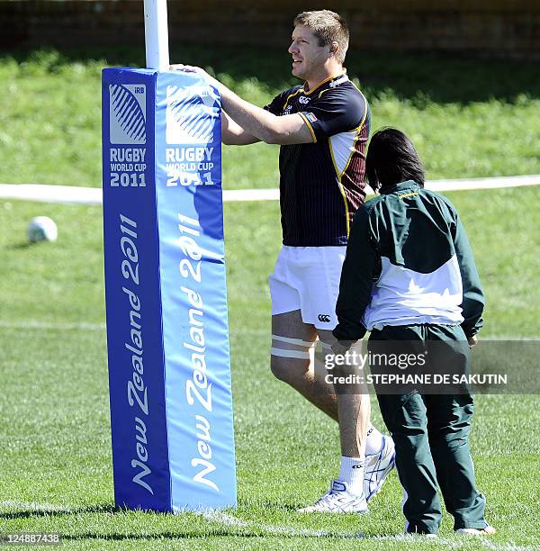 South African Springbok player Frans Steyn stretches with physiotherapist Rene Naylor during a training session on September 14, 2011 in Wellington...