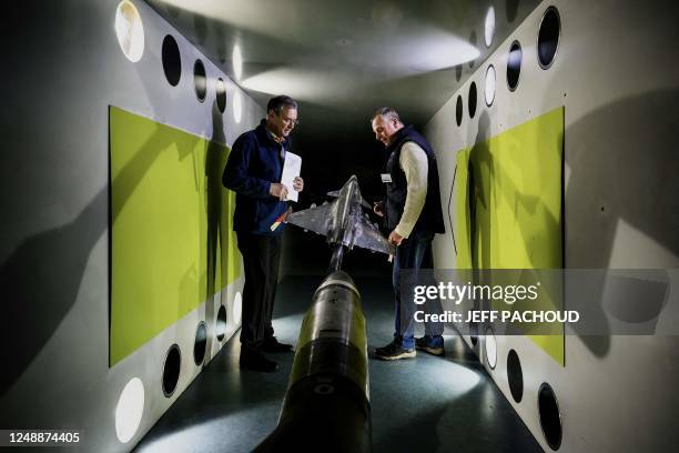 Scientists of the French aeronautics, space and defense research lab work on an airplane model in the wind tunnel department at Modane-Avrieux ONERA...