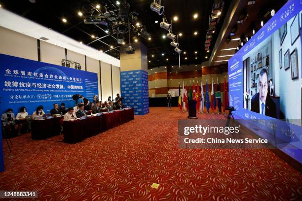 People attend a sub forum as Egypt's former Prime Minister Essam Sharaf speaks via video link during Global Think Tanks Online Forum on International...