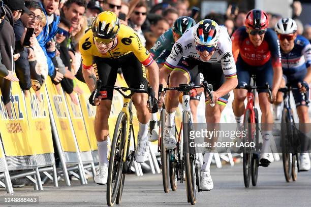 Team Jumbo's Slovenian rider Primoz Roglic crosses the finish line first ahead of Quick-Step Belgian rider Remco Evenepoel during the 1st stage of...