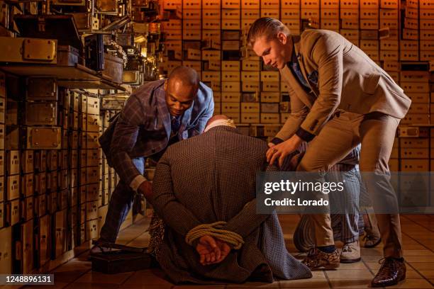 portrait of a vintage gangster man in an old bank vault - bank robber stock pictures, royalty-free photos & images