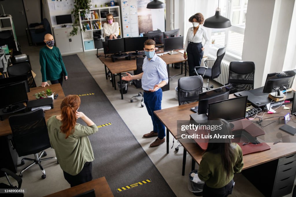 Staff meeting in office with social distancing