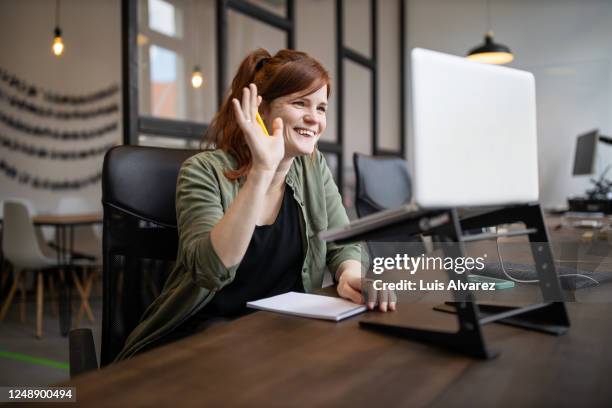 businesswoman greeting colleagues on video call - sick coworker stock pictures, royalty-free photos & images