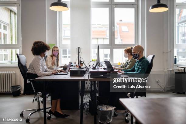 business people return back to work after covid-19 pandemic - protective face mask office stock pictures, royalty-free photos & images