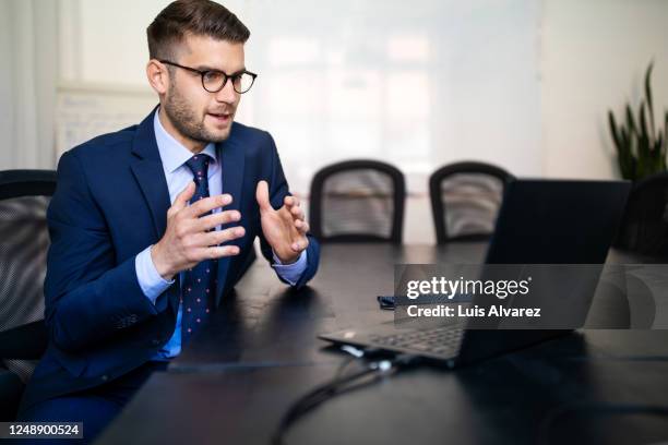 businessman explaining new plan to team over video call - meeting candid office suit stock pictures, royalty-free photos & images