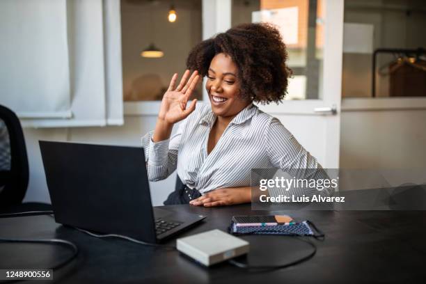 businesswoman having video call meeting in office - brown hair waves stock pictures, royalty-free photos & images