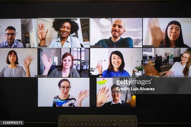 video meeting on desktop screen - sventolare la mano foto e immagini stock