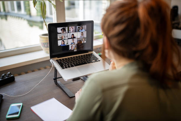 woman having online meeting with colleagues working remotely - zoom stock pictures, royalty-free photos & images