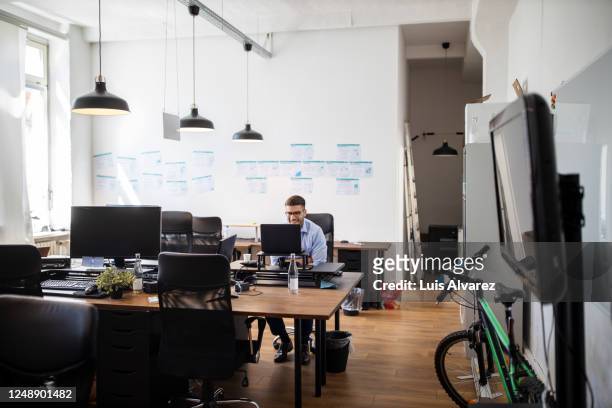 businessman video conferencing from his desk - employee engagement remote stock pictures, royalty-free photos & images