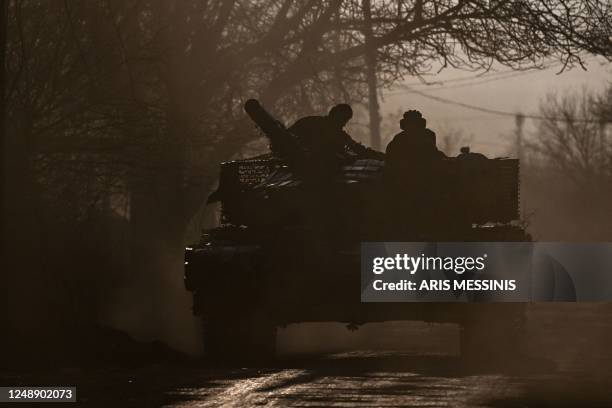 Ukrainian servicemen with a T64 tanks move towards Bakhmut direction, in Donetsk Oblast region, on March 20, 2023. - The head of Russia's Wagner...