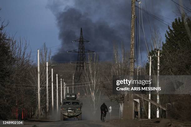 Smoke rises from the direction of Bakhmut as it is seen from the town of Chasiv Yar on March 20, 2023. - The head of Russia's Wagner mercenary group...