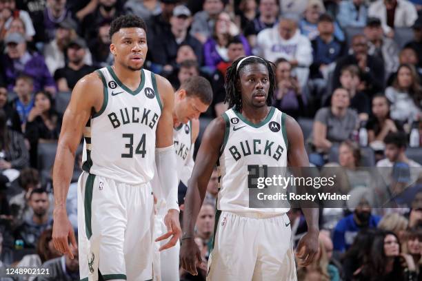 Giannis Antetokounmpo and Jrue Holiday of the Milwaukee Bucks look on during the game against the Sacramento Kings on March 13, 2023 at Golden 1...