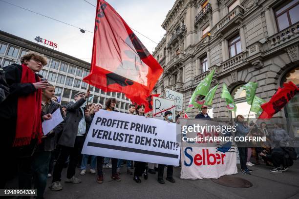 Member of Young Socialists Switzerland party stage a demonstration in front of the headquarters of Credit Suisse bank and next to a UBS offices on...